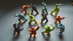 Riot of colour - twelve small coloured figures with clubs