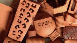 A pile of terracotta objects including one with the word