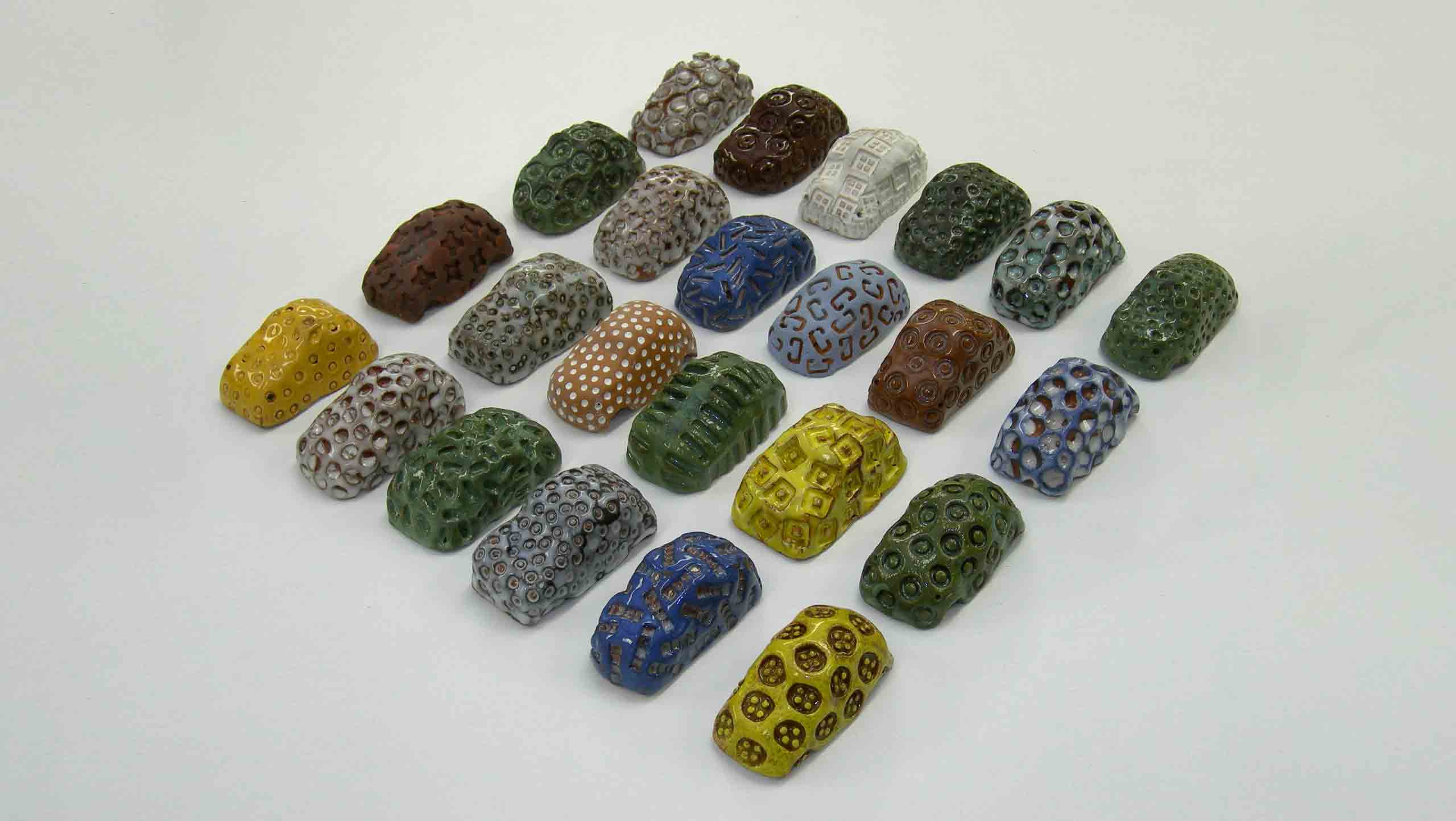 Karparc: They are in many different colours and impressed with different shaped implements.