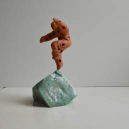 Quantum leap - perforated terracotta figure on a glazed base